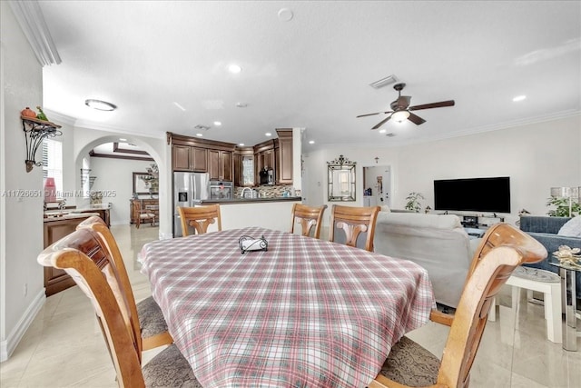 dining area with ornamental molding and ceiling fan