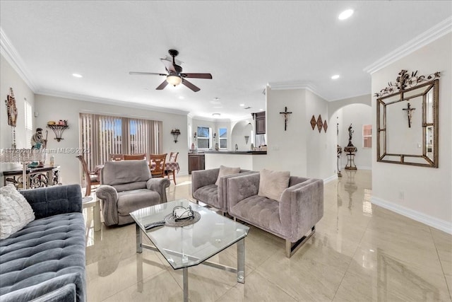 living room with ornamental molding and ceiling fan