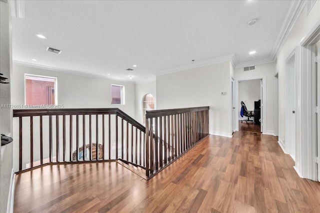 hallway featuring ornamental molding and hardwood / wood-style floors