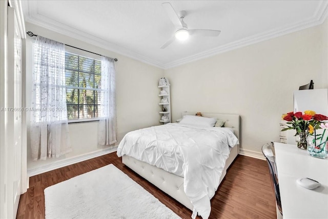 bedroom with ceiling fan, ornamental molding, and dark hardwood / wood-style floors