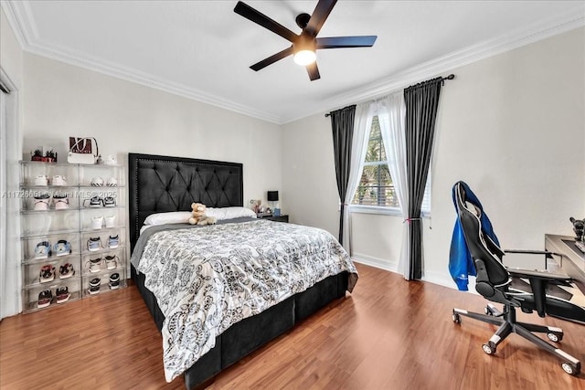 bedroom featuring hardwood / wood-style flooring, ceiling fan, and ornamental molding