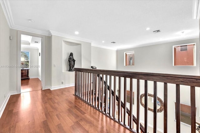 hallway featuring hardwood / wood-style flooring and crown molding