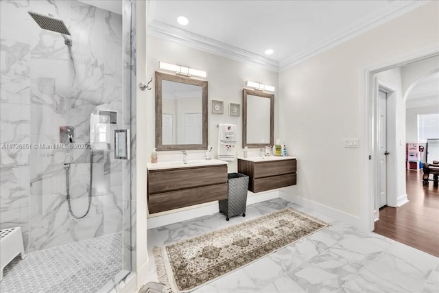 bathroom featuring vanity, a shower with shower door, and crown molding