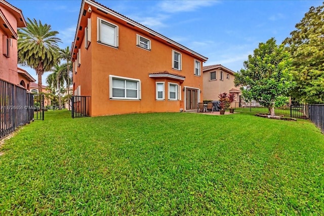 back of house with a lawn