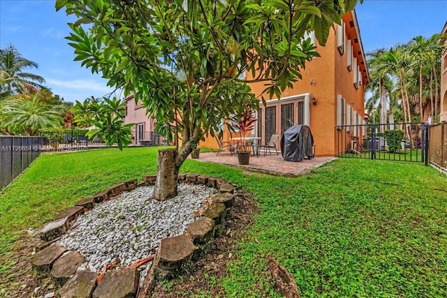 view of yard with french doors and a patio area