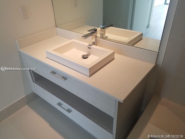 bathroom featuring tile patterned flooring and vanity