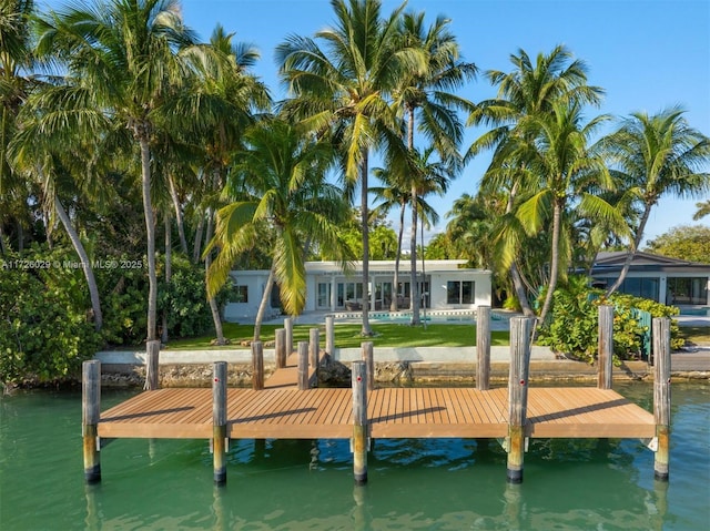 view of dock with a swimming pool and a water view