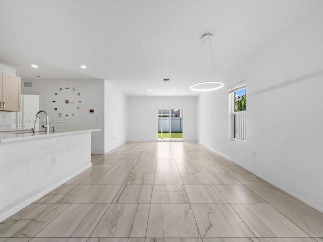 unfurnished living room with sink