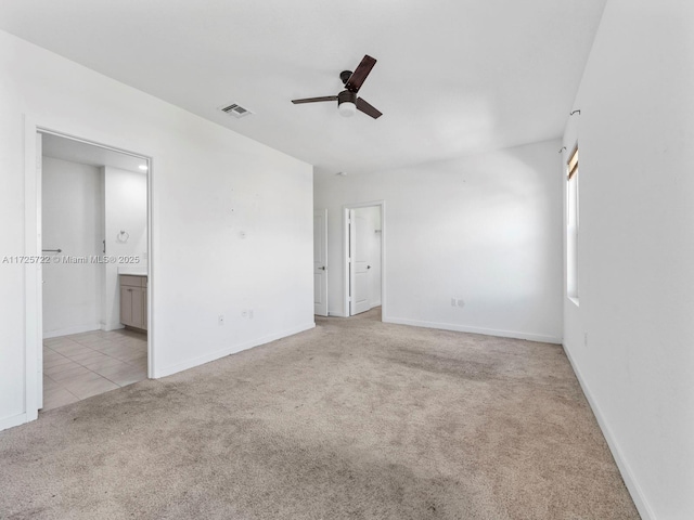 carpeted spare room with ceiling fan