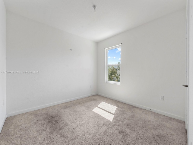 unfurnished room featuring carpet flooring