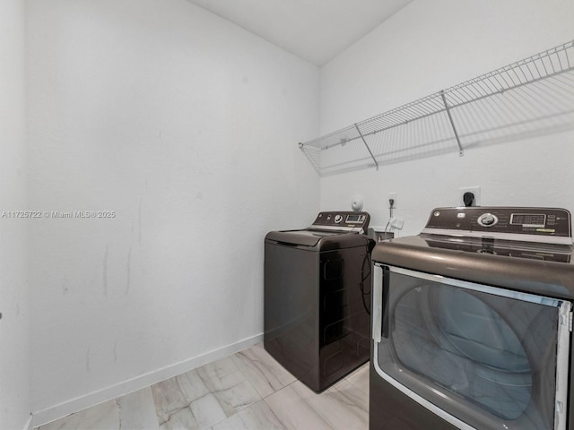 clothes washing area with separate washer and dryer