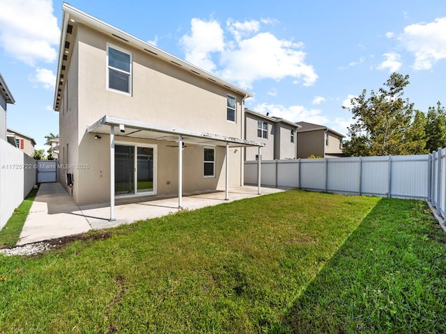 back of property featuring a yard and a patio area