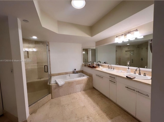 bathroom with a raised ceiling, shower with separate bathtub, and vanity