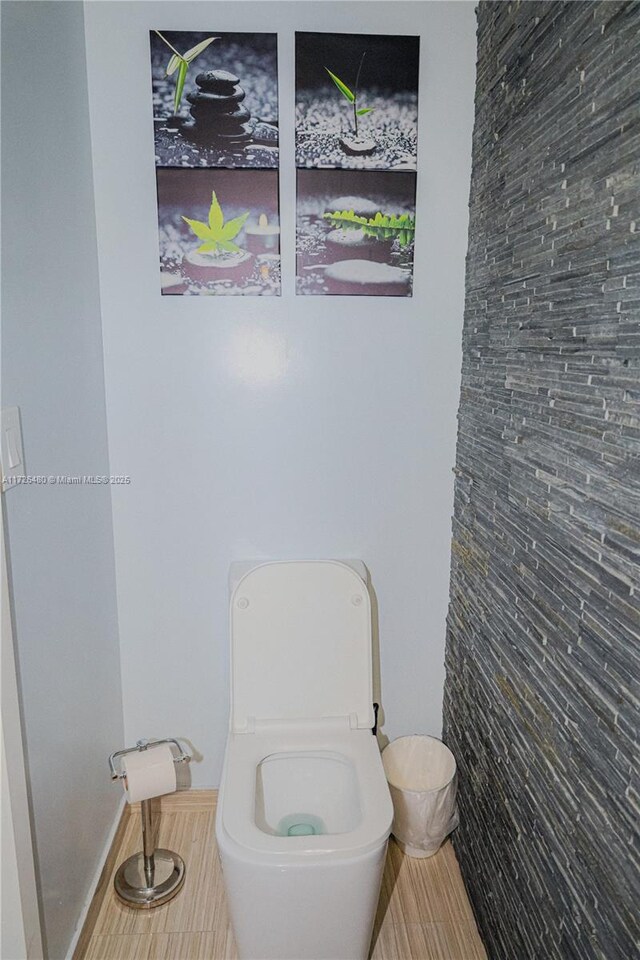 bathroom with toilet and tile patterned flooring