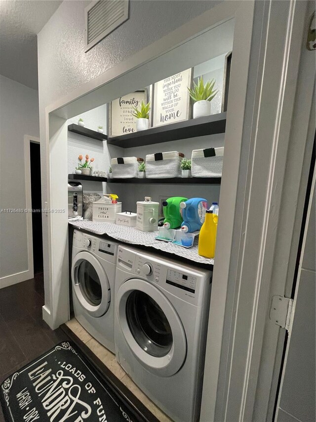 washroom with dark hardwood / wood-style flooring and independent washer and dryer