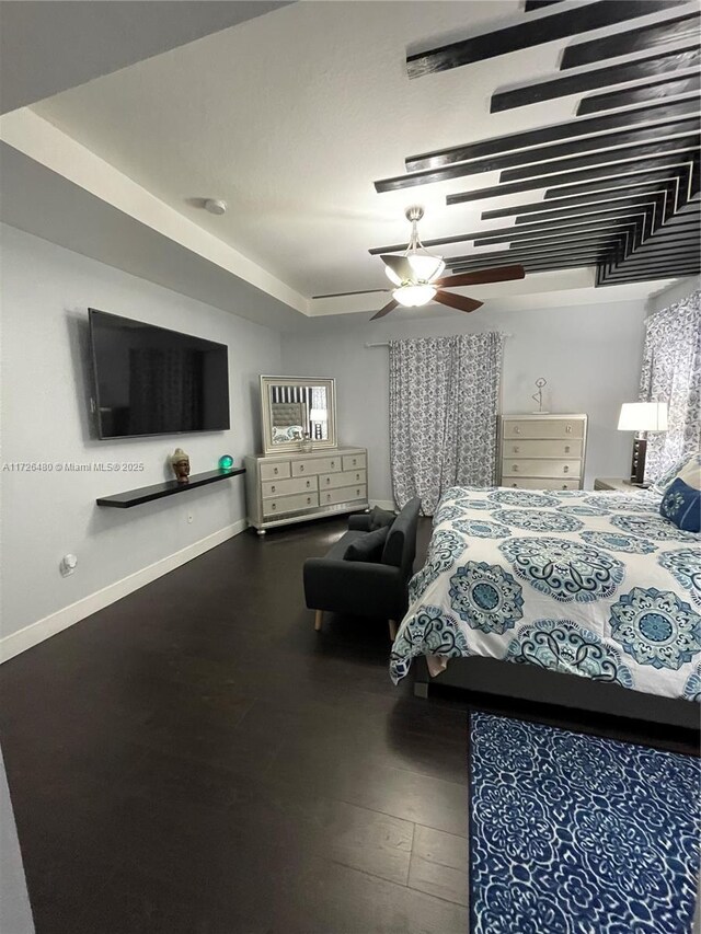 bedroom featuring ceiling fan and a raised ceiling