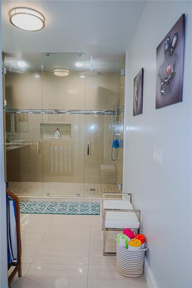 bathroom with tile patterned floors and an enclosed shower