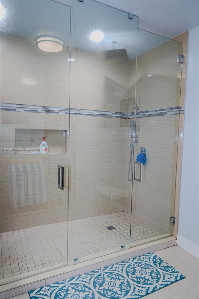 bathroom featuring tile patterned flooring and a shower with door