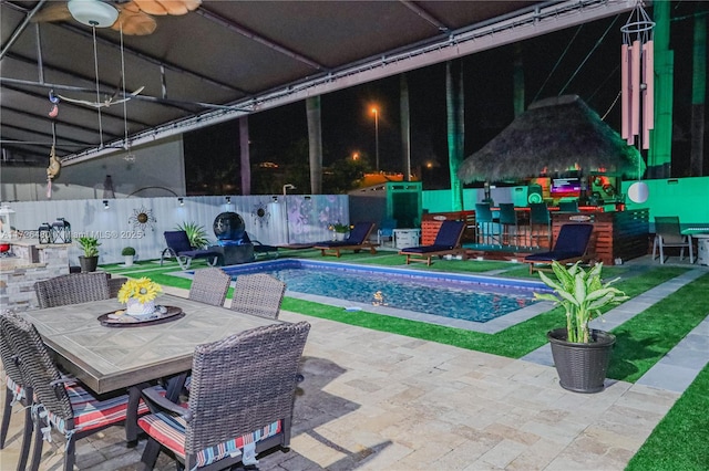 view of swimming pool with ceiling fan and a patio