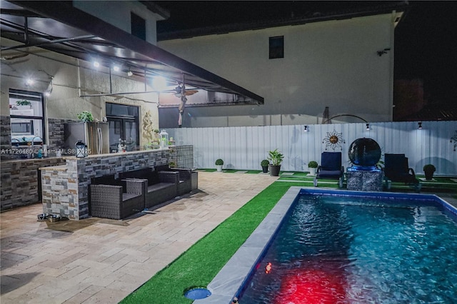 view of swimming pool with a patio and a bar