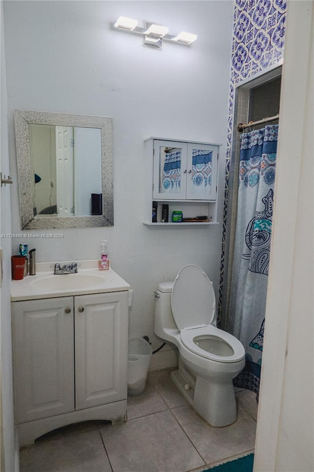 bathroom with vanity, toilet, and tile patterned flooring