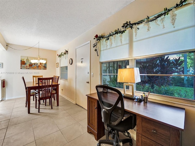 office area featuring a notable chandelier, a textured ceiling, and light tile patterned floors