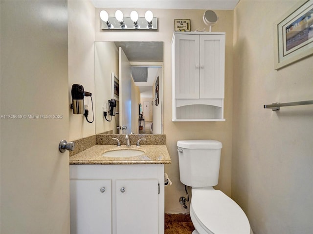 bathroom featuring vanity and toilet