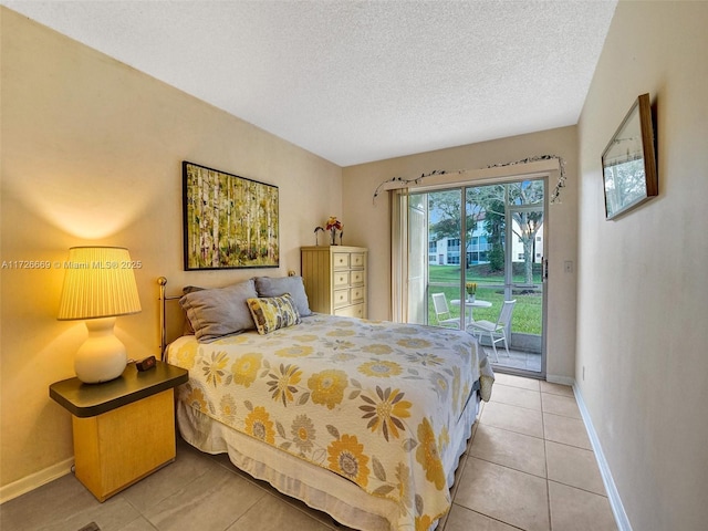 tiled bedroom featuring access to exterior and a textured ceiling