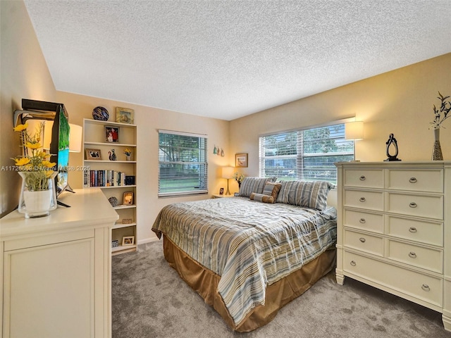 carpeted bedroom with a textured ceiling