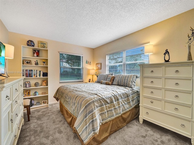 carpeted bedroom featuring a textured ceiling