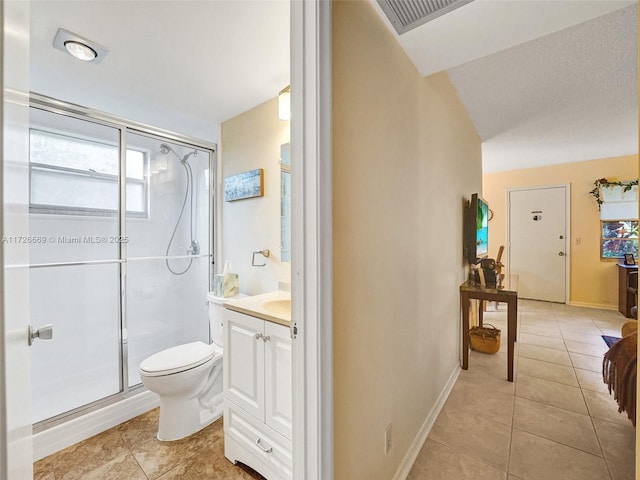 bathroom with toilet, tile patterned flooring, a shower with door, and vanity