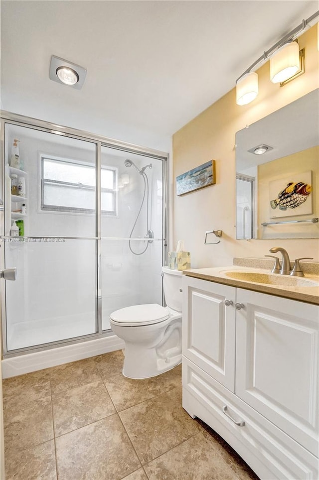 bathroom with walk in shower, tile patterned flooring, vanity, and toilet