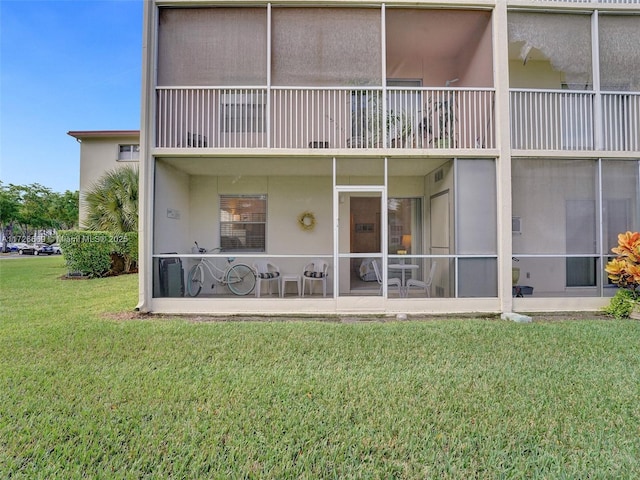 back of property with a yard and a patio