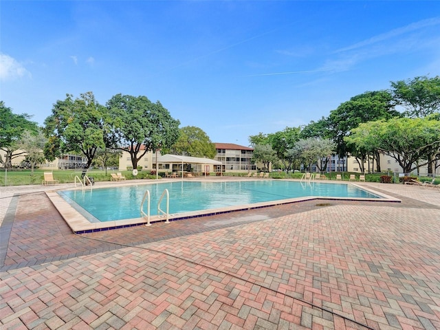 view of swimming pool with a patio