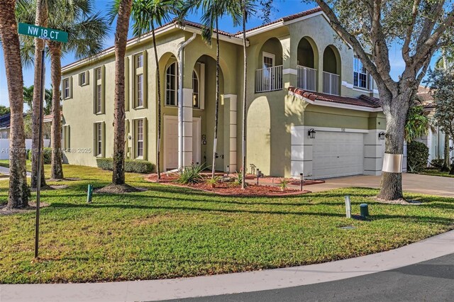 mediterranean / spanish-style home with a balcony, a garage, and a front lawn