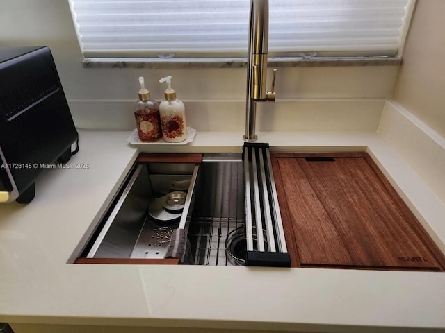 interior details featuring light countertops and a sink