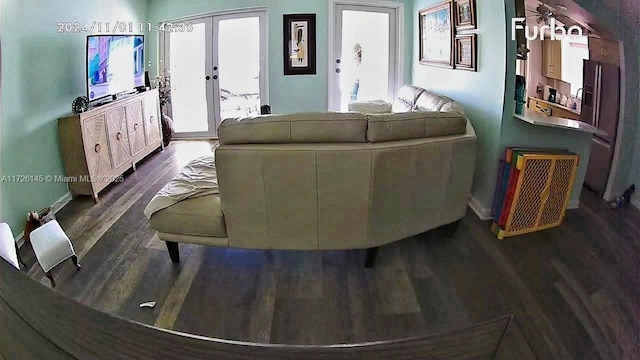 living room with baseboards, dark wood-style floors, and french doors