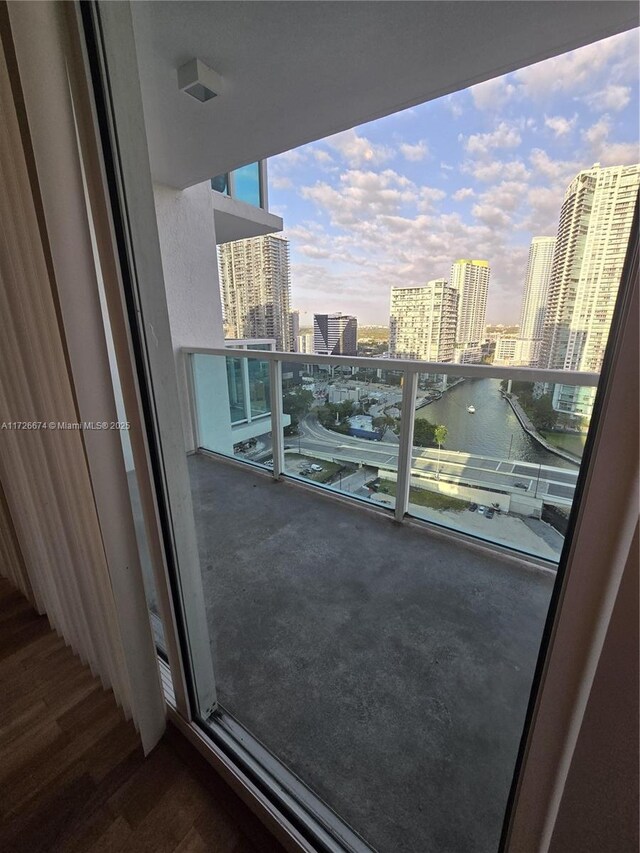 empty room with a textured ceiling, dark hardwood / wood-style floors, and expansive windows