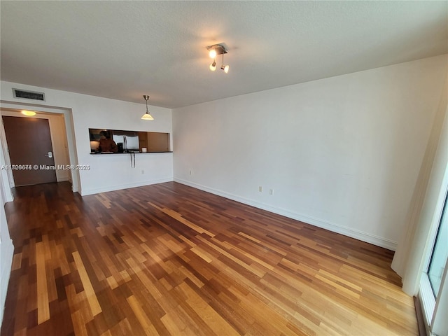 unfurnished living room with hardwood / wood-style flooring