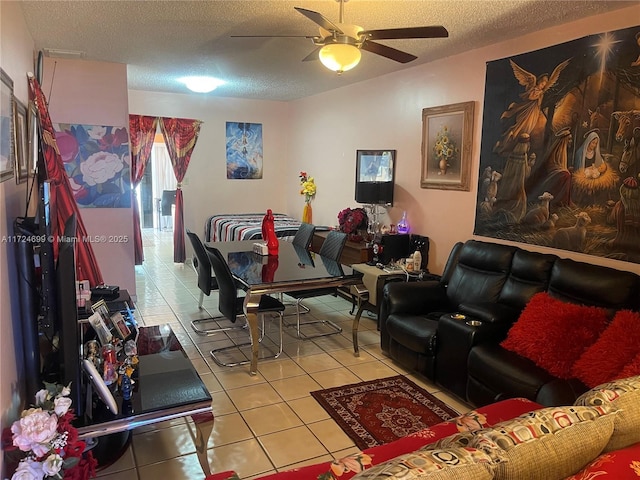 living room featuring a textured ceiling, ceiling fan, and tile patterned flooring