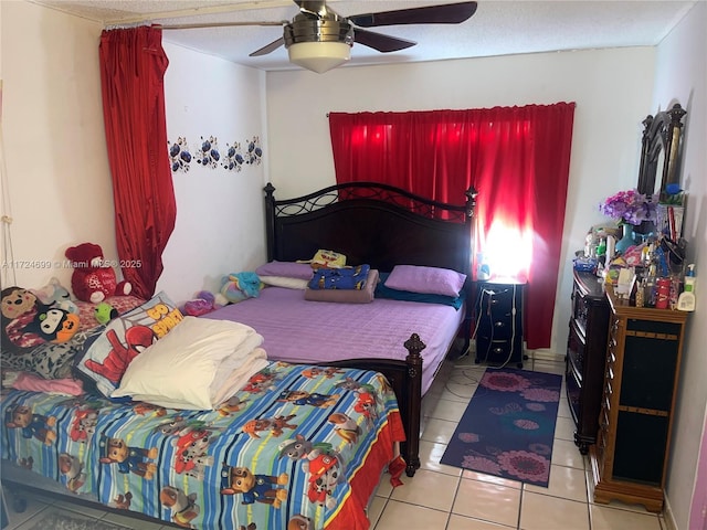 tiled bedroom with a textured ceiling and ceiling fan