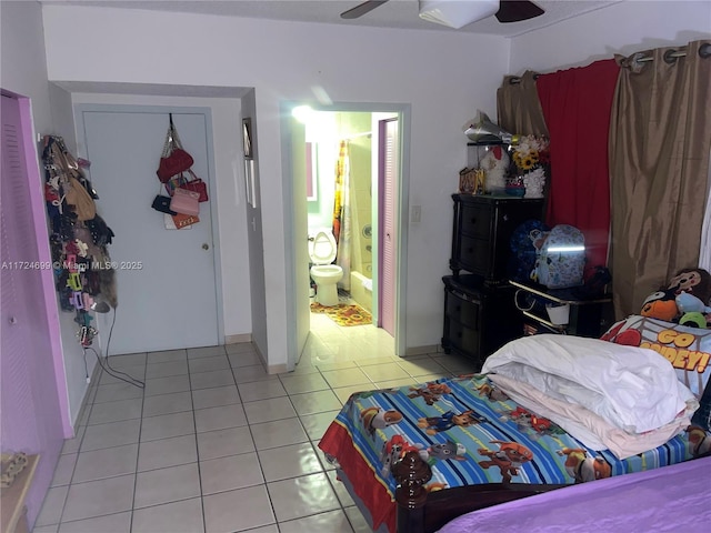 bedroom featuring light tile patterned flooring, ceiling fan, and ensuite bathroom