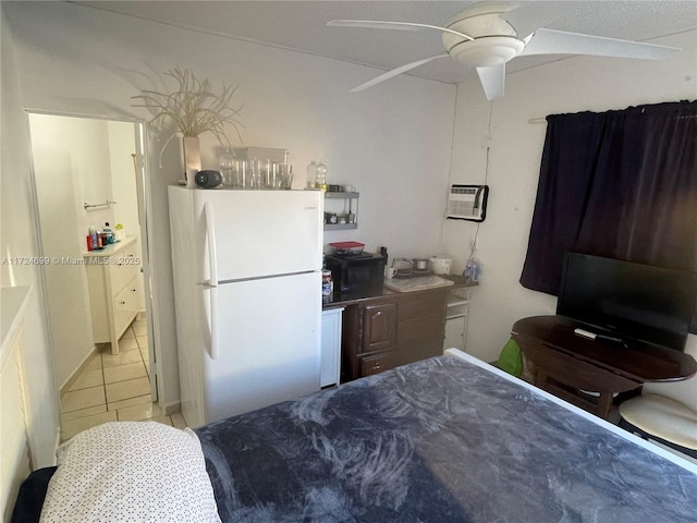 tiled bedroom with ceiling fan, white refrigerator, and an AC wall unit