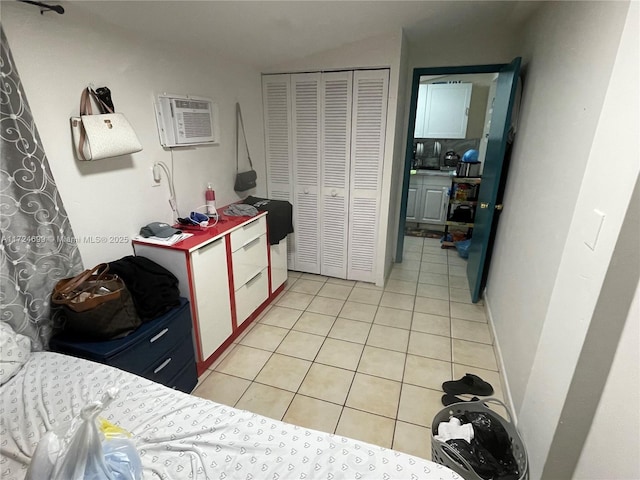 tiled bedroom with an AC wall unit and a closet