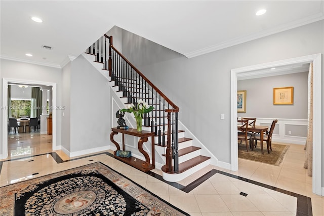 staircase featuring tile patterned flooring and ornamental molding