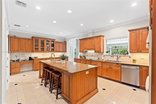 kitchen with stainless steel dishwasher, a center island with sink, a breakfast bar, crown molding, and sink