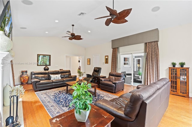 living room with vaulted ceiling, ceiling fan, and light hardwood / wood-style floors