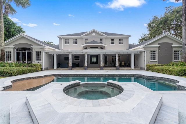 rear view of property featuring a patio area, a swimming pool with hot tub, and a pergola