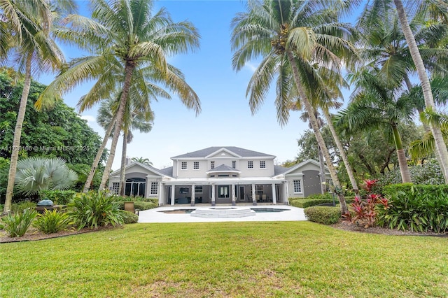 rear view of property featuring a yard and a patio