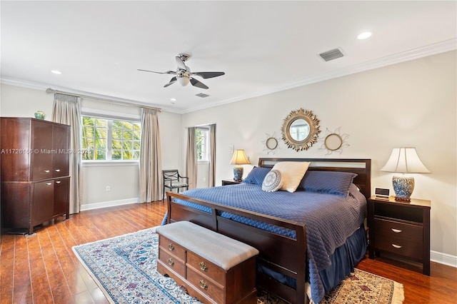 bedroom with wood-type flooring, ceiling fan, and ornamental molding